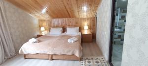 a bedroom with a bed with two towels on it at Guest House Tamta in Stepantsminda