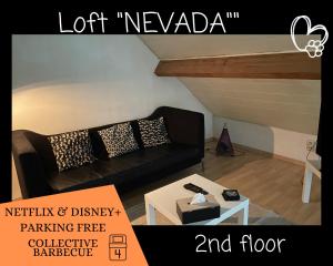 a living room with a black couch and a table at L'ARIZONA Dinant - Appart Arizona, Studio Montana - Garden, Free Parking, Dog ok in Dinant