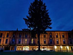 a building with a tree in front of it at HI Geres - Pousada de Juventude do Gerês in Geres