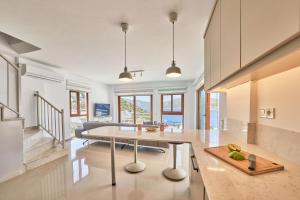 a kitchen with a dining table and a living room at Villa Elmas in Kalkan
