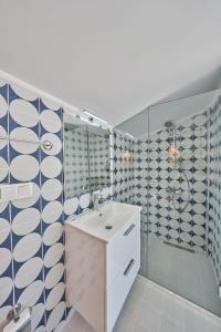a bathroom with a sink and blue and white tiles at Villa Elmas in Kalkan