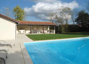 a swimming pool in a yard with a gazebo at Domaine Manon in Buzon