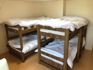 Postel nebo postele na pokoji v ubytování I・ecoⅢ（アイエコスリー）