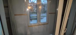 a sliding glass door with a window in a room at Центр 2-поверх кондиціонер біля озера балкон The best in Ivano-Frankivsk