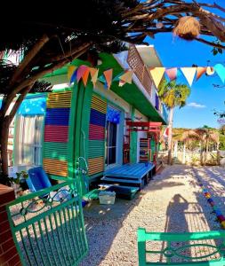 a colorful house with a bench in front of it at Happy Island Miyako in Miyako Island