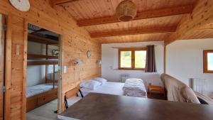 a room with a table and a bunk bed at Les Chatcureuils in Montclar