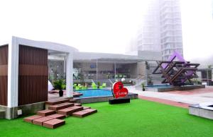 a view of a building with a pool and green grass at The BEST @ Genting Highland ( FREE WIFI ) in Genting Highlands