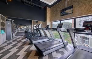 a gym with several treadmills in a room at The BEST @ Genting Highland ( FREE WIFI ) in Genting Highlands