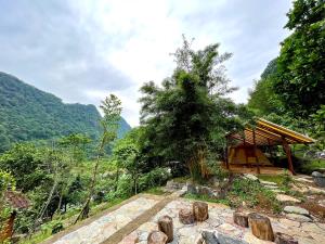 a building with a roof on top of a mountain at Thang Hen Lake - Thang Hen Glamping & Eco Outdoor in Thăng Hen