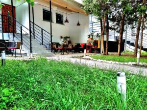 a house with chairs and tables in a yard at TipTop Hotel CITY CENTER in Chişinău