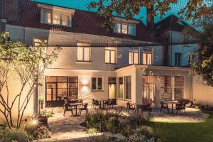 a house with a patio with tables and chairs at Raphaëlles Boutique b&b in Bruges
