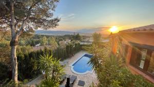 a villa with a swimming pool and a sunset at Bellavista in Begur