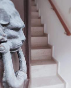 a statue of a lion with its trunk next to a staircase at Piazza Vittoria Apartment in Carini