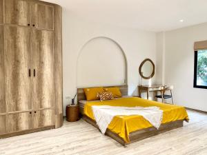 a bedroom with a bed and a large wooden cabinet at Sushi House Ba Dinh homestay alley38 Hang Bun in Hanoi