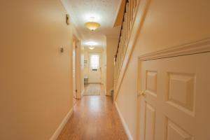 a hallway with a door leading to a room with a hallway at The Forest House in Brandon