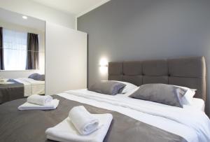 a bedroom with a large bed with towels on it at Split Urban Getaway in Split