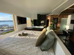 a bedroom with a large bed and a large window at Sunset in Six-Fours-les-Plages