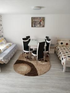 ein Esszimmer mit Tisch und Stühlen und einem Bett in der Unterkunft Căsuța Bunicilor in Dorna Cîndrenilor + 73 Fotos