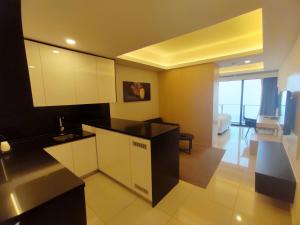 a kitchen with white cabinets and a black counter top at The BEST @ Genting Highland ( FREE WIFI ) in Genting Highlands