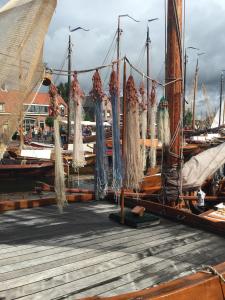 a group of boats tied to a dock with nets at Holiday in Spakenburg t Afferhuus in Spakenburg