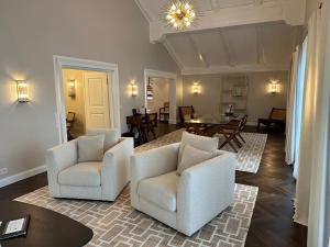 a living room with two chairs and a table at Bio Design Boutique Landhaus St Georg in Bad Wiessee