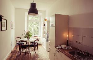 a kitchen with a table and chairs and a window at Schloss Altenhagen in Kröpelin