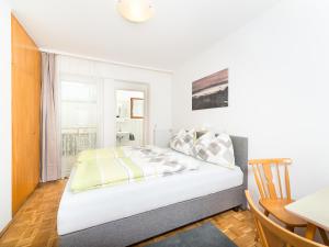 Postel nebo postele na pokoji v ubytování Gästehaus Genf
