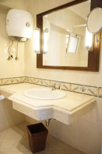 a bathroom with a sink and a mirror at Adel's villa in Sharm El Sheikh