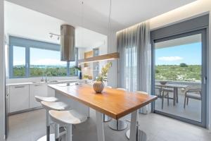 a kitchen with a table and chairs and a dining room at Le Mont Blanc in Kounoupidhianá