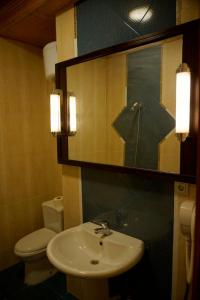 a bathroom with a sink and a toilet and a mirror at Adel's villa in Sharm El Sheikh