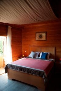 a bedroom with a large bed with a red blanket at Adel's villa in Sharm El Sheikh