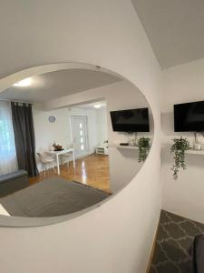 a living room with a large round mirror on the wall at Apartment Maria in Zadar