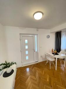 a living room with a table and a table and chairs at Apartment Maria in Zadar