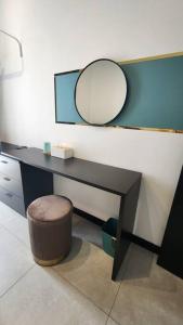 a desk with a mirror and a stool in a room at The Nova by The City Collection in Kuala Lumpur