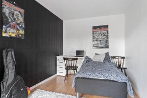 a bedroom with a bed and a desk with chairs at House of love in Landskrona