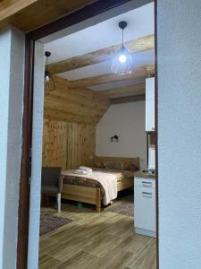 Cet appartement comprend une chambre avec un lit et une table ainsi qu'une cuisine. dans l'établissement Sumski kutak, à Žabljak
