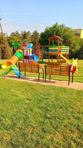 a park with several different types of playground equipment at Domki Apartamentowe WIKING in Władysławowo