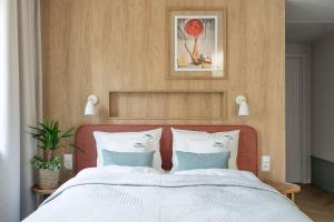 Ένα ή περισσότερα κρεβάτια σε δωμάτιο στο Baltic Wave Boutique Apartments with sauna and gym