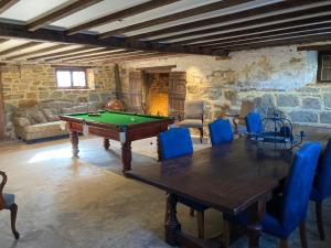 a room with a pool table and blue chairs at Faversham House in York