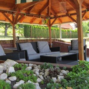 un patio con sofás, una mesa y un techo en Belle Vue, en Cserszegtomaj