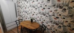 a room with a table and a wall with photographs at Lorf Hostel&Apartments in Krakow