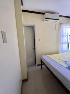 a bedroom with a bed and a window and a heater at Jimsville executive homes in Liloan