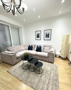 a living room with a couch and a table at London Charm - Comfortable Room in Spacious House in London
