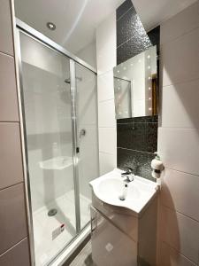 a white bathroom with a shower and a sink at London Charm - Comfortable Room in Spacious House in London