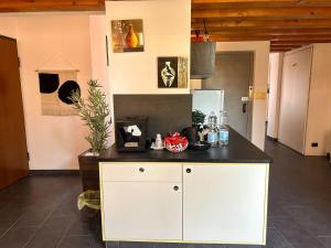 a kitchen with a white island in a room at Al Castello in Ferrara
