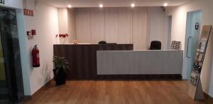 an office with a reception desk in the middle of a room at Hotel Rota Malhoa in Figueiró dos Vinhos
