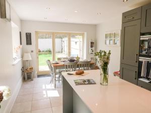 a kitchen and dining room with a table and chairs at East View in Cheltenham