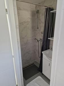 a bathroom with a shower with a shower curtain at Apartman Bella in Drage