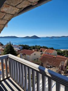 a view of the water from the balcony of a house at Apartman Bella in Drage