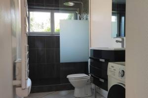 a bathroom with a toilet and a sink and a window at TOK TOK Ronchin Maison Proche toutes commodités Lille in Ronchin +13 photos